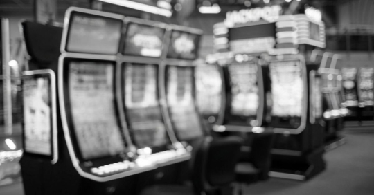 Blurred slot machines are seen in a casino.