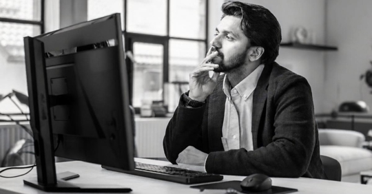 Man looking at his schedule at work noticing his hours have been cut